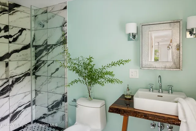 a bathroom with a sink toilet and shower