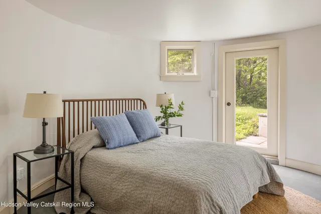 a bedroom with a bed and window