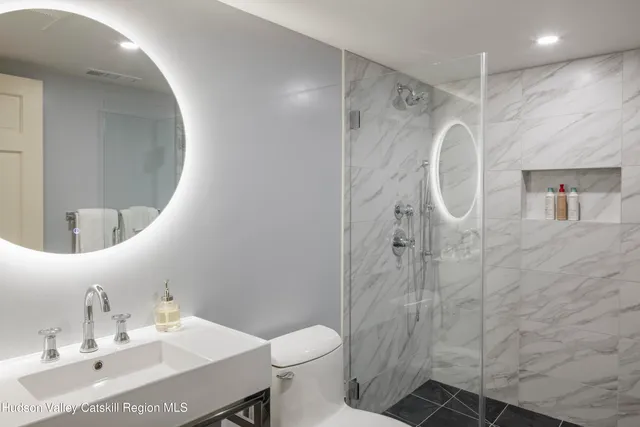 a bathroom with a sink toilet and shower