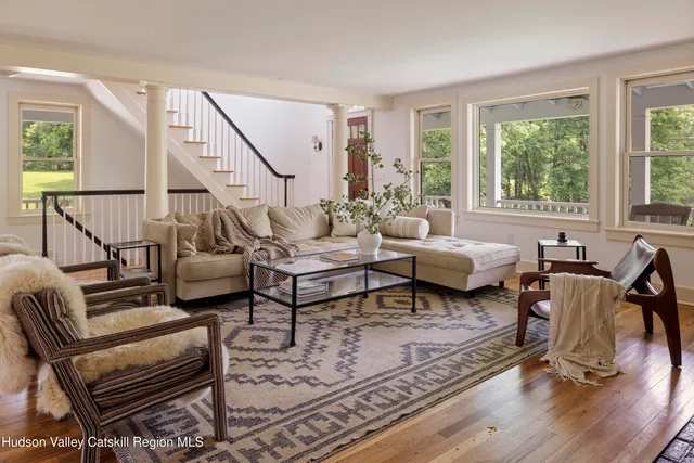 a living room with furniture and a potted plant