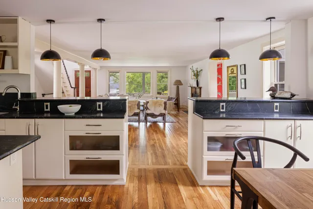 a kitchen with stainless steel appliances granite countertop a stove and a wooden floors
