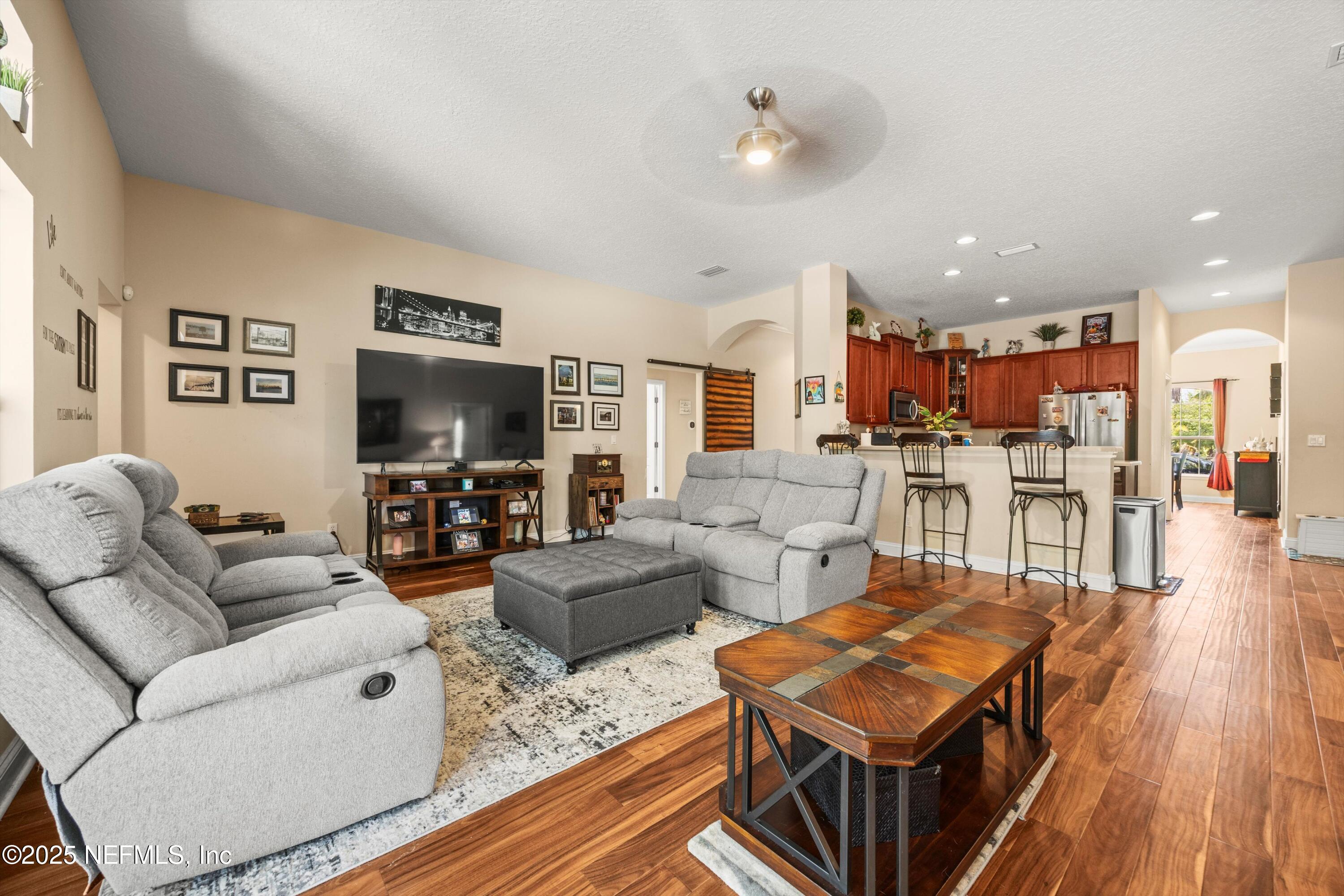 648 Battersea Drive St. Augustine, FL 32095 - Photo 16 of 59 a living room with furniture and a flat screen tv