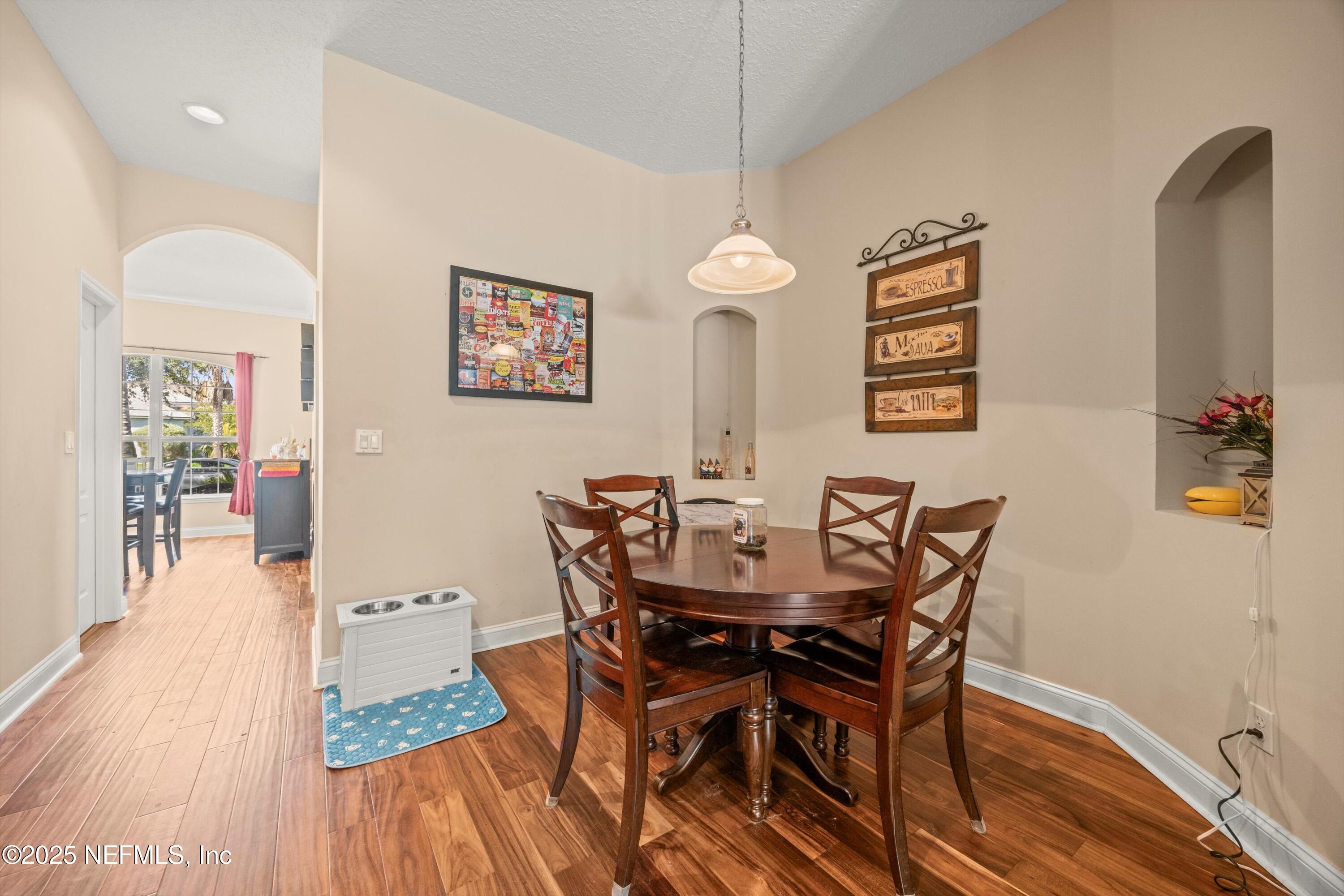 648 Battersea Drive St. Augustine, FL 32095 - Photo 19 of 59 a view of a dining room with furniture and wooden floor