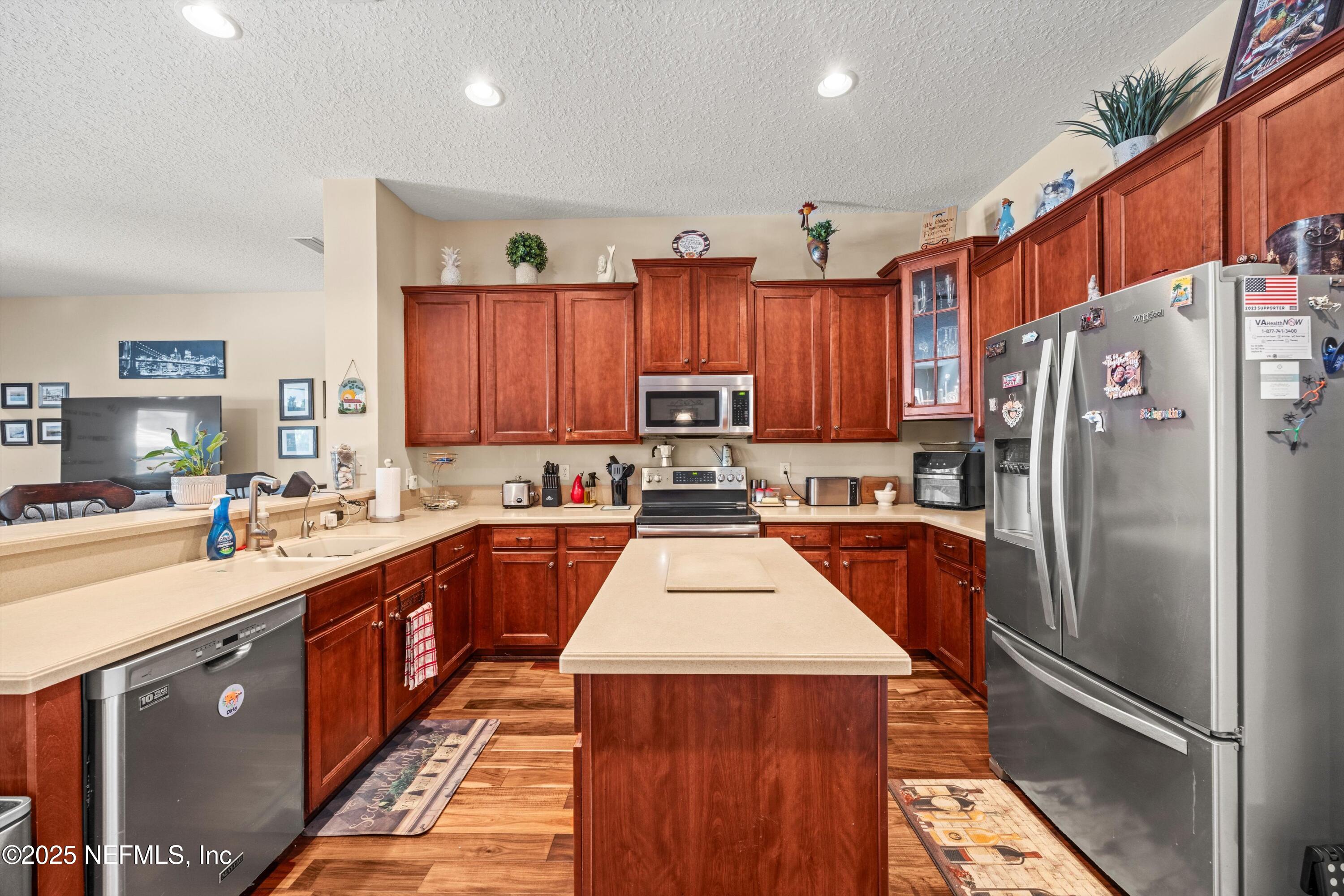 648 Battersea Drive St. Augustine, FL 32095 - Photo 21 of 59 a kitchen with stainless steel appliances granite countertop a refrigerator and a sink