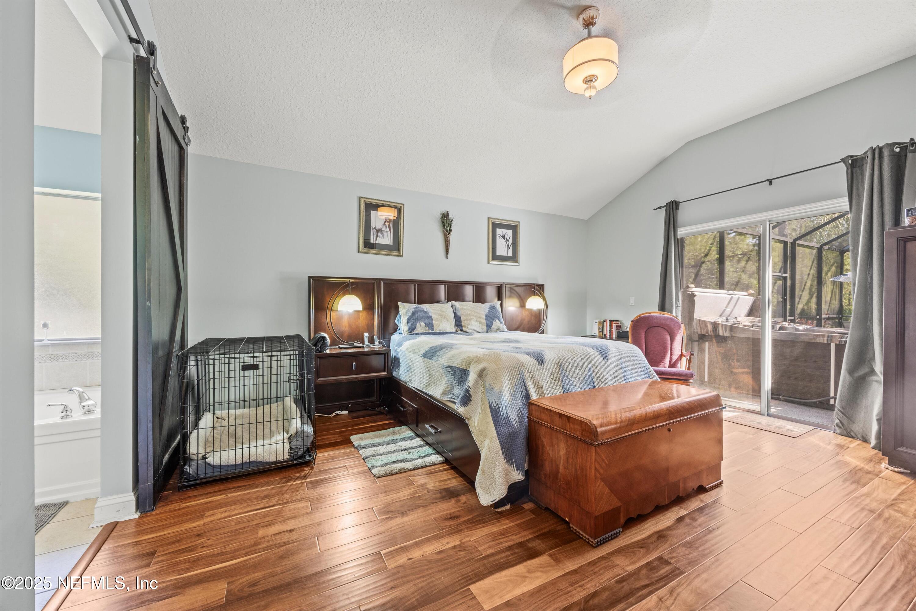 648 Battersea Drive St. Augustine, FL 32095 - Photo 24 of 59 a bedroom with a bed window and a table