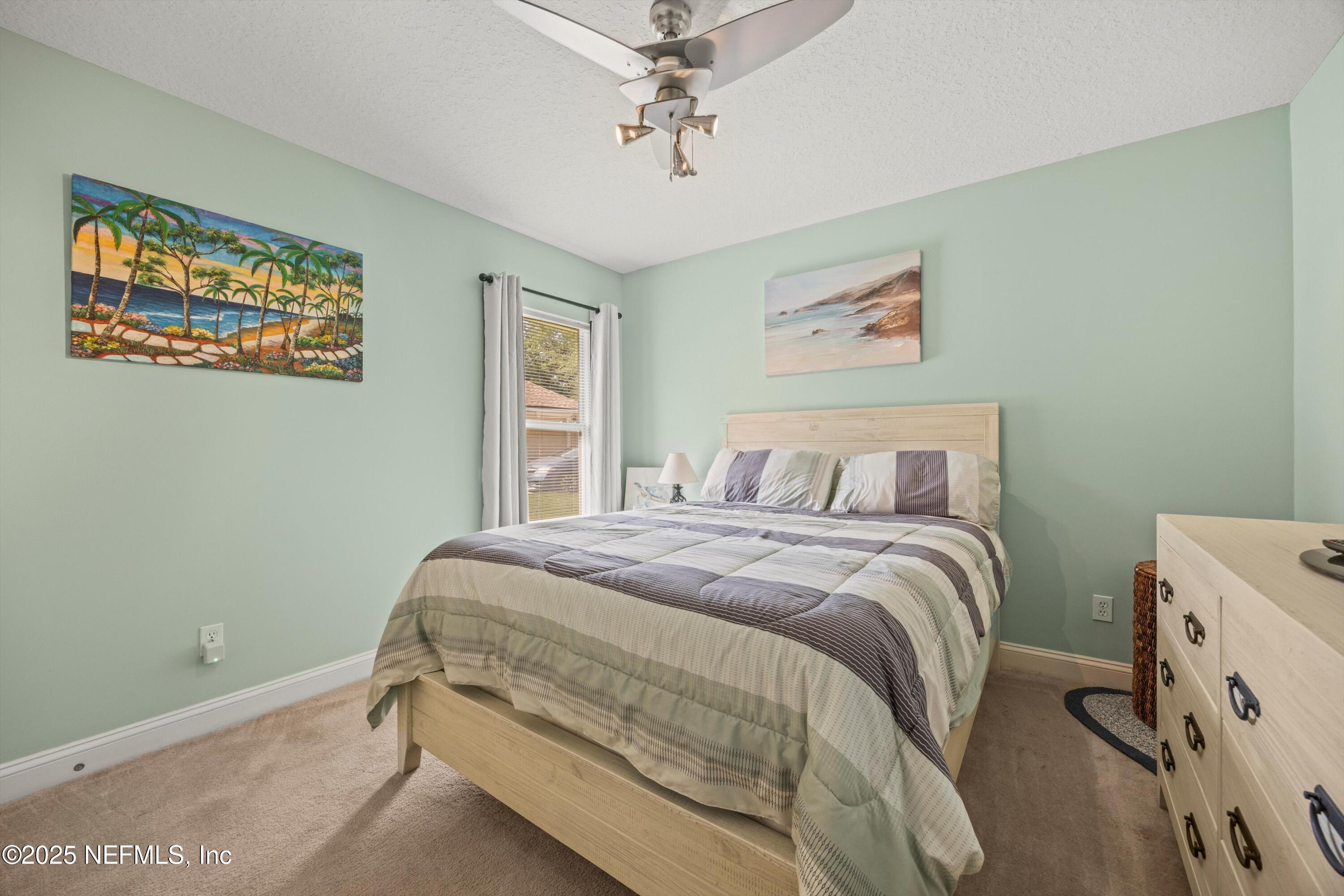 648 Battersea Drive St. Augustine, FL 32095 - Photo 31 of 59 a bedroom with a bed and a window