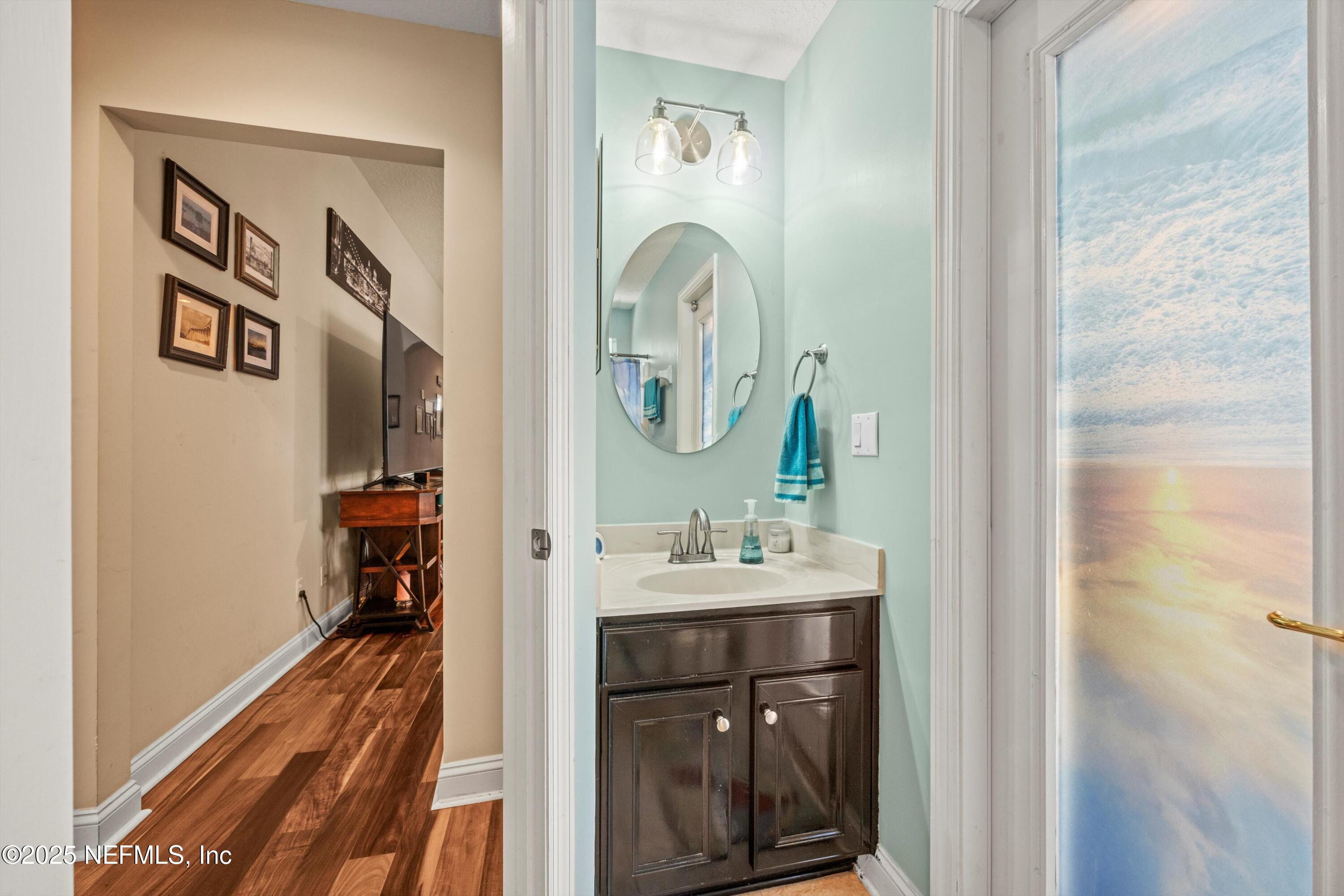 648 Battersea Drive St. Augustine, FL 32095 - Photo 33 of 59 a bathroom with a sink a mirror and a shower