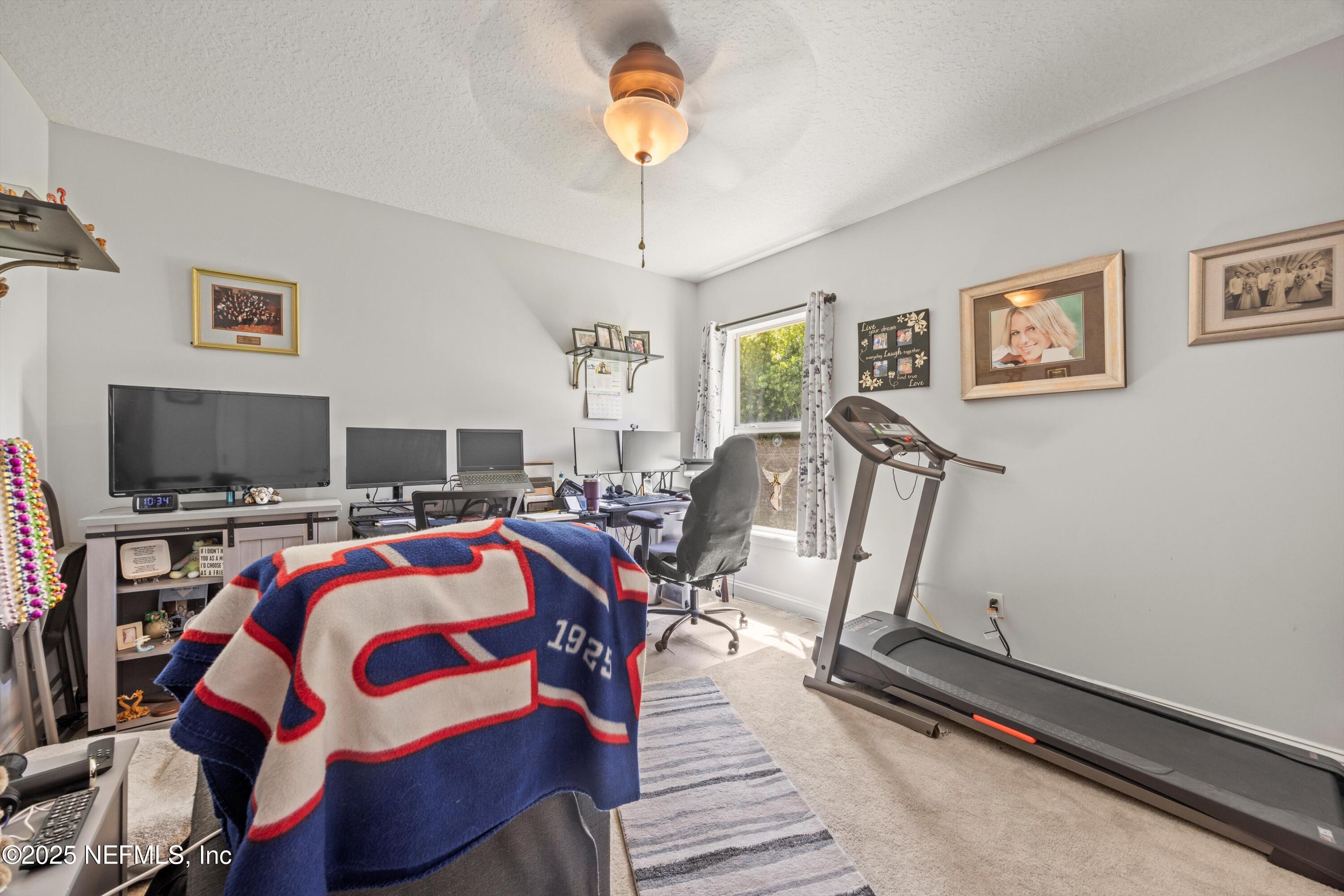 648 Battersea Drive St. Augustine, FL 32095 - Photo 35 of 59 a view of a livingroom with furniture and a flat screen tv