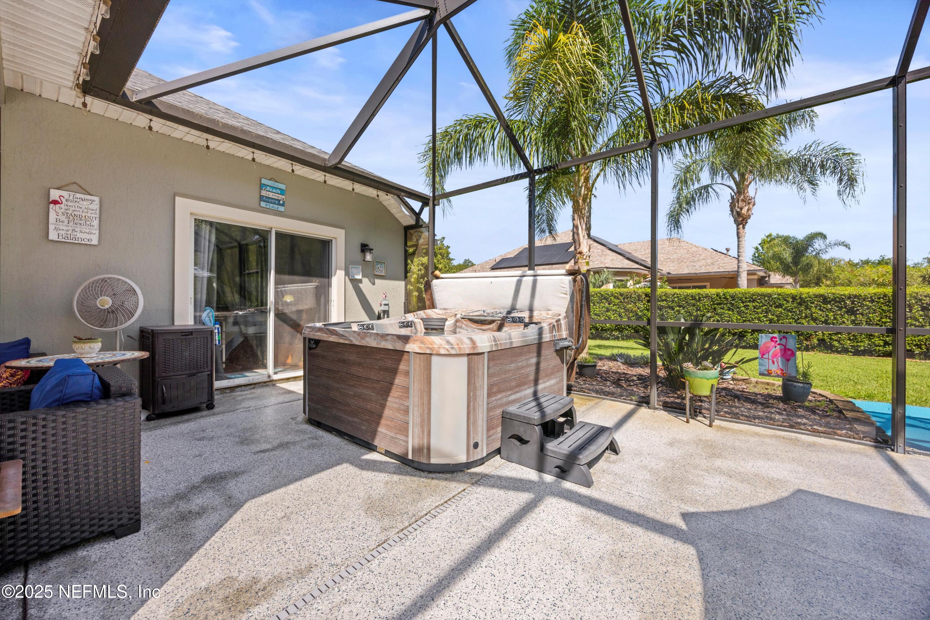 648 Battersea Drive St. Augustine, FL 32095 - Photo 40 of 59 a view of a patio with couches and table and chairs under an umbrella