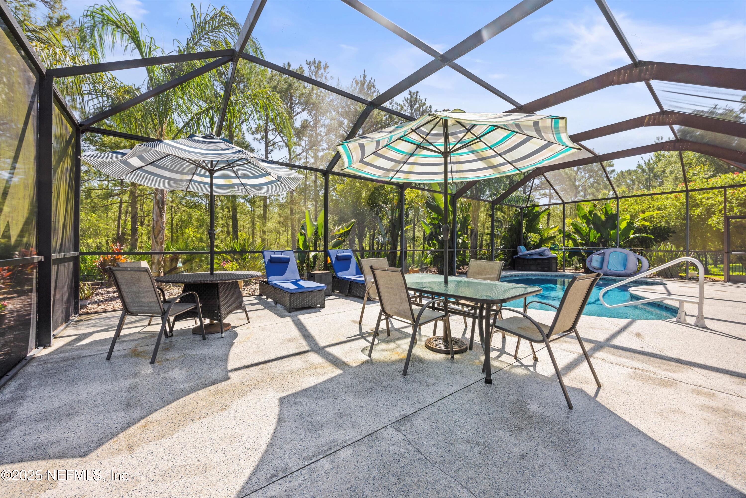 648 Battersea Drive St. Augustine, FL 32095 - Photo 43 of 59 a view of a dinning table and chairs in the patio