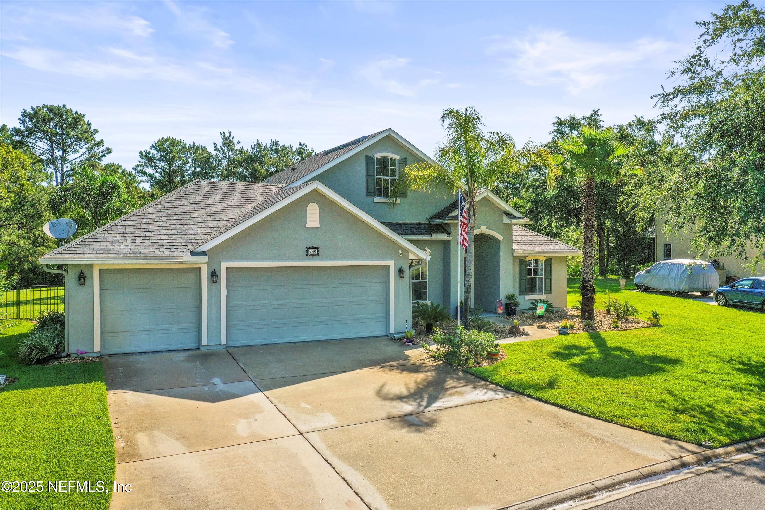648 Battersea Drive St. Augustine, FL 32095 - Photo 4 of 59 a front view of a house with garden