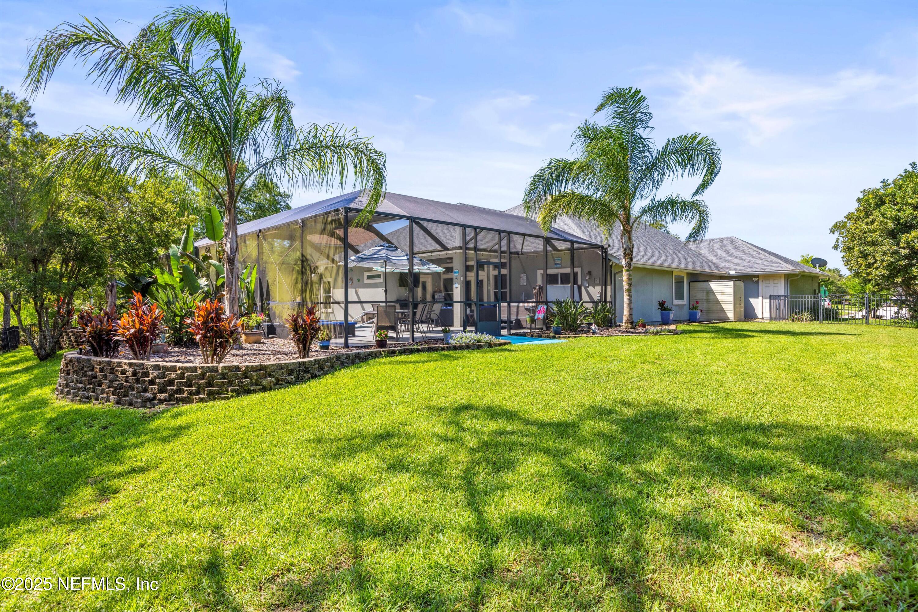 648 Battersea Drive St. Augustine, FL 32095 - Photo 50 of 59 a view of a house with swimming pool and a yard