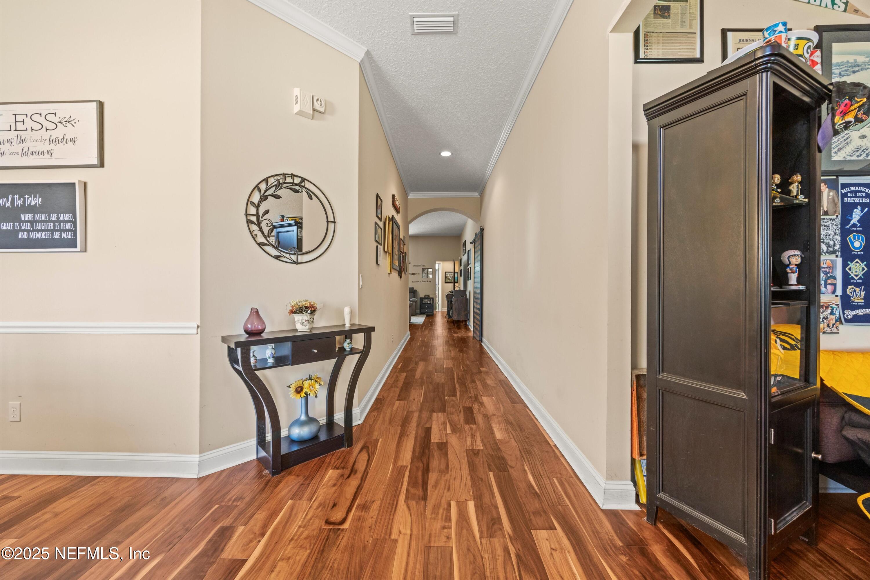 648 Battersea Drive St. Augustine, FL 32095 - Photo 8 of 59 a view of a hallway with wooden floor