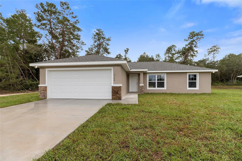 14162 Southwest 16th Place Dunnellon, FL 34432 - Photo 1 of 15 front view of a house with a yard