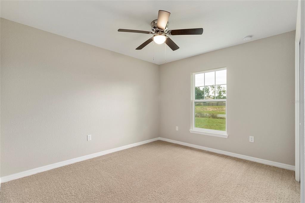 14162 Southwest 16th Place Dunnellon, FL 34432 - Photo 11 of 15 an empty room with a window and a fan