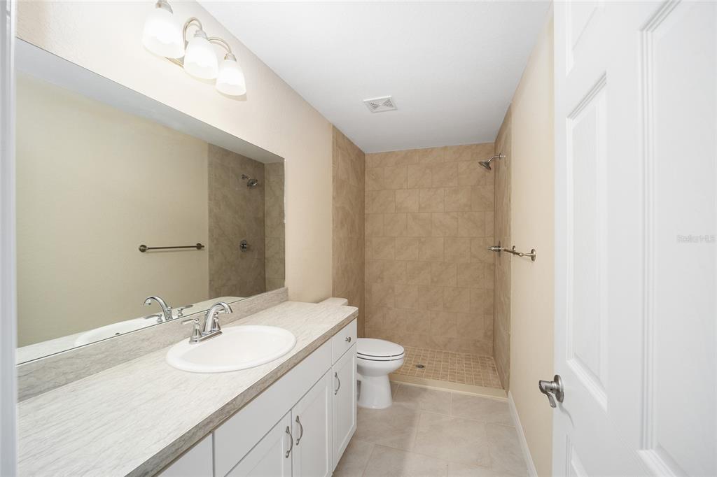 14162 Southwest 16th Place Dunnellon, FL 34432 - Photo 7 of 15 a bathroom with a sink a toilet and shower