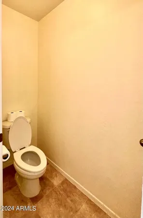a white toilet sitting next to a white sink