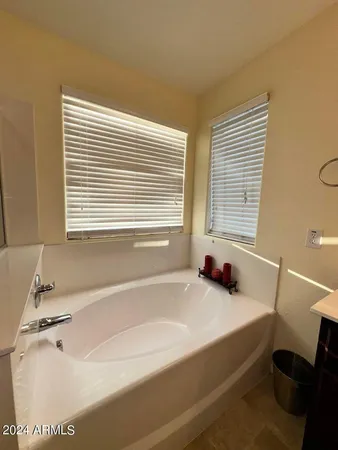 a bathroom with a tub sink and a window
