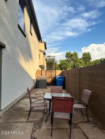 a backyard of a house with table and chairs