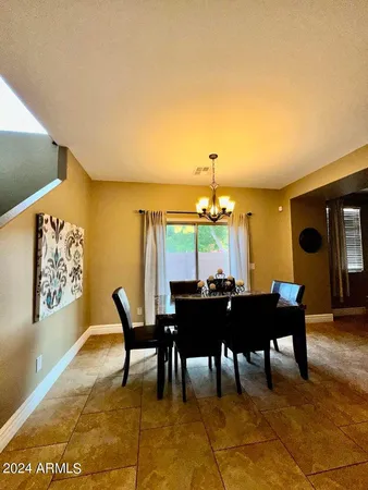a dining room with furniture and chandelier