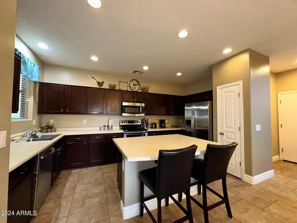 a large kitchen with a table and chairs