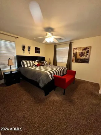 a bedroom with bed and a chandelier