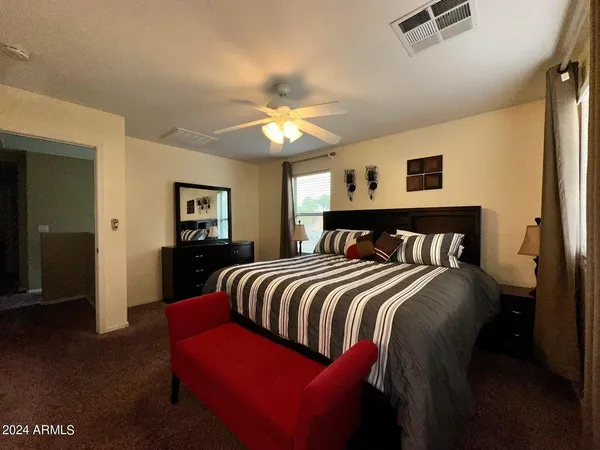 a bedroom with a bed and a chandelier