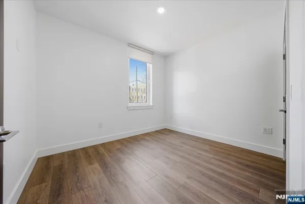 a view of hallway with wooden floor