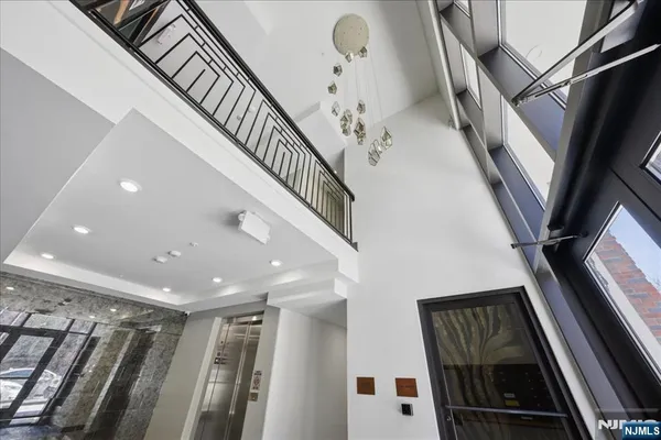 a view of a living room and a room with wooden floor