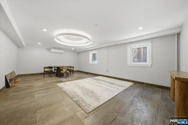 a living room with furniture a rug and a window