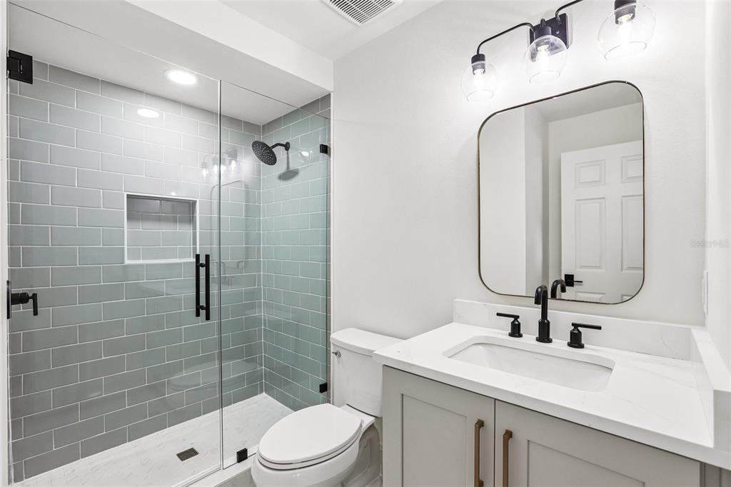 1012 Morfield Lane Brandon, FL 33511 - Photo 32 of 100 a bathroom with a sink a toilet and shower