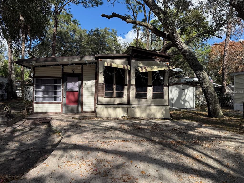 a front view of a house with a tree