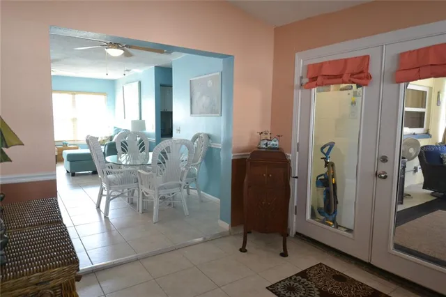 a view of a dining room with furniture and a chandelier
