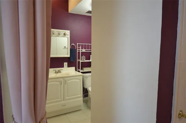 a bathroom with a sink vanity and a mirror