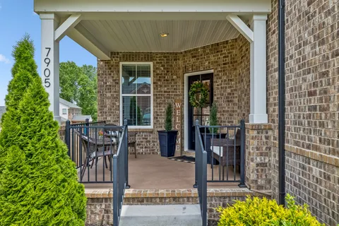 a front view of a house with outdoor seating and plants
