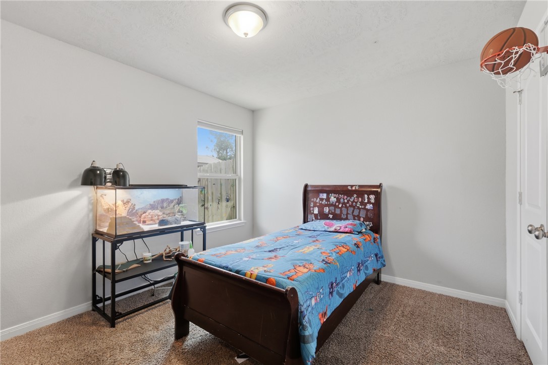 2725 Porter's Way Bryan, TX 77803 - Photo 15 of 19 a bedroom with a bed and a lamp on table