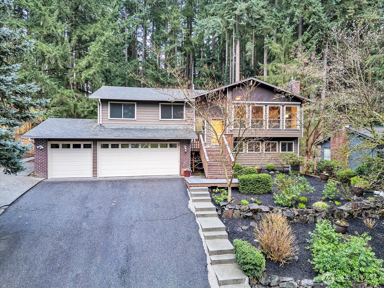 20921 28th Avenue Southeast Bothell, WA 98021 - Photo 1 of 37 a front view of a house with a yard and garage