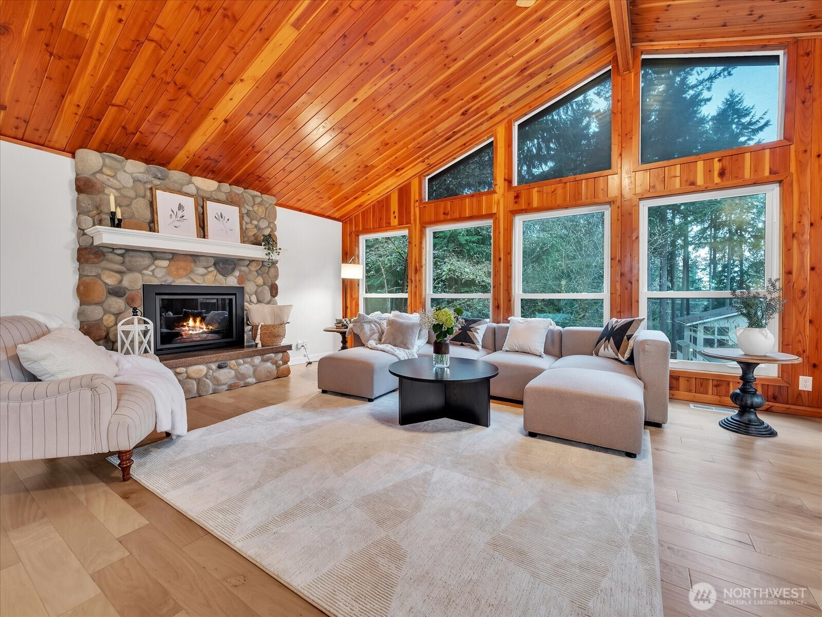 20921 28th Avenue Southeast Bothell, WA 98021 - Photo 3 of 37 a living room with furniture a fireplace and floor to ceiling windows
