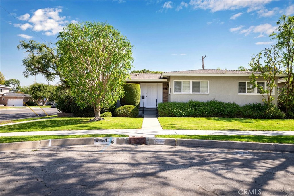 2154 North Studebaker Road Long Beach, CA 90815 - Photo 1 of 37 a front view of a house with a yard and trees