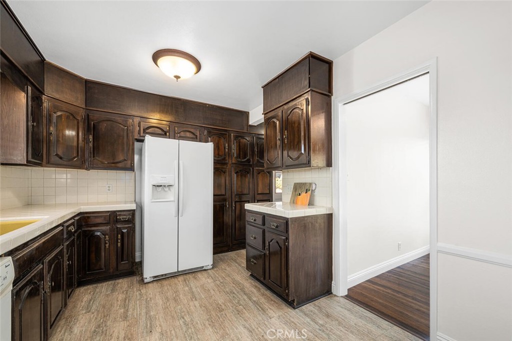 2154 North Studebaker Road Long Beach, CA 90815 - Photo 11 of 37 a kitchen with stainless steel appliances a refrigerator and a sink