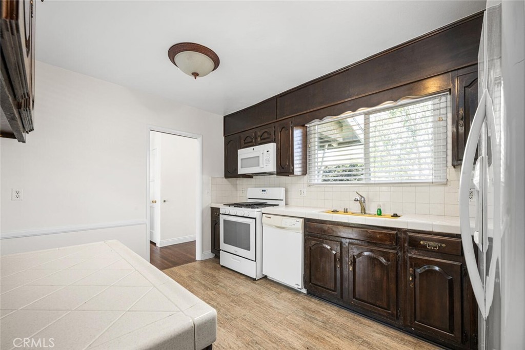 2154 North Studebaker Road Long Beach, CA 90815 - Photo 13 of 37 a kitchen with stainless steel appliances granite countertop a sink and a stove