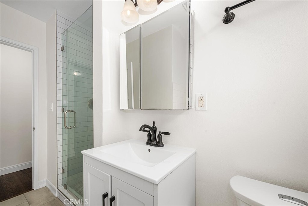 2154 North Studebaker Road Long Beach, CA 90815 - Photo 25 of 37 a bathroom with a sink a toilet and mirror