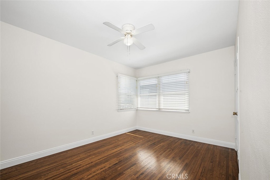 2154 North Studebaker Road Long Beach, CA 90815 - Photo 27 of 37 an empty room with wooden floor fan and windows