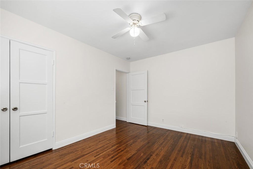 2154 North Studebaker Road Long Beach, CA 90815 - Photo 29 of 37 an empty room with wooden floor and a ceiling fan