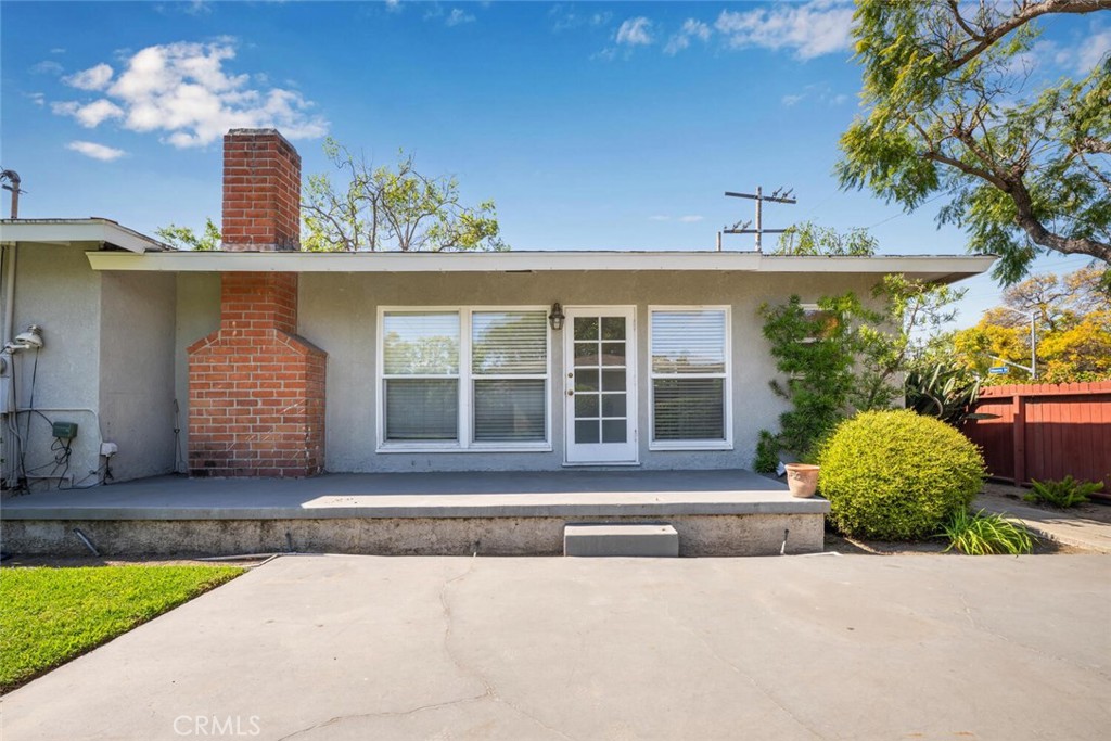 2154 North Studebaker Road Long Beach, CA 90815 - Photo 36 of 37 a front view of a house with a yard and a garage