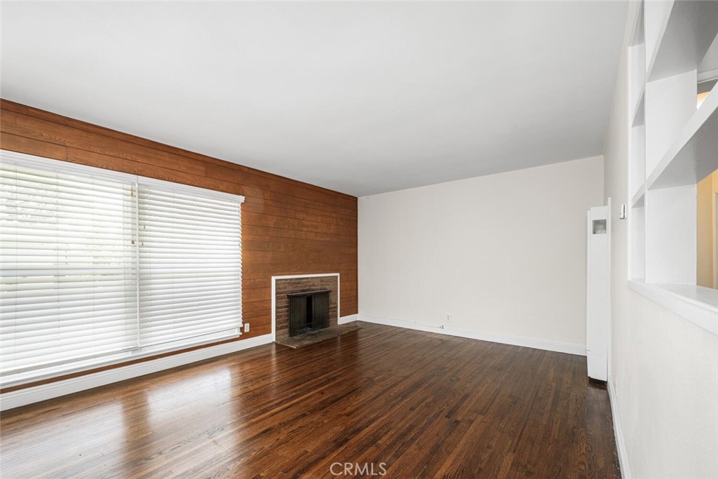 2154 North Studebaker Road Long Beach, CA 90815 - Photo 4 of 37 an empty room with wooden floor and windows