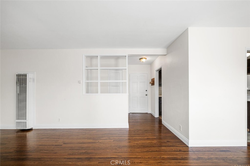 2154 North Studebaker Road Long Beach, CA 90815 - Photo 6 of 37 a view of an empty room with wooden floor and a window