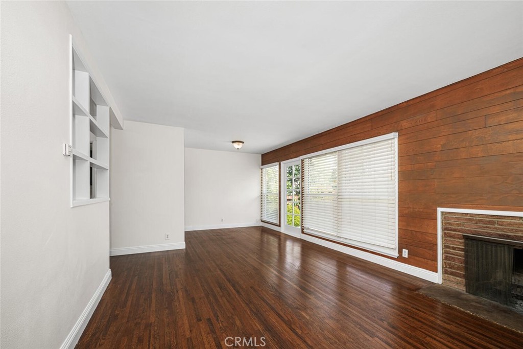 2154 North Studebaker Road Long Beach, CA 90815 - Photo 7 of 37 a view of an empty room with wooden floor and a window
