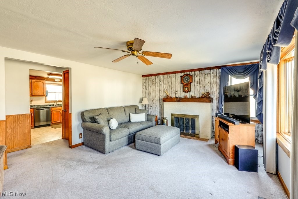 4220 Lake Heights Road Northwest Canton, OH 44708 - Photo 6 of 48 Living room with fireplace, light carpet, and bay window