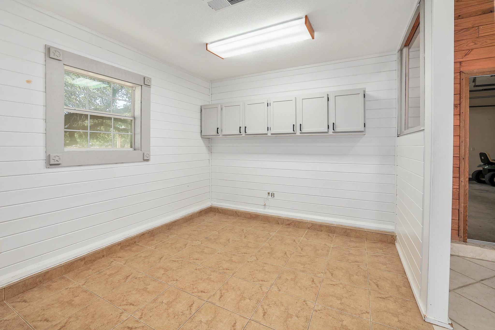 3900 Shell Road Georgetown, TX 78628 - Photo 35 of 40 Empty room with wood walls and light tile patterned floors